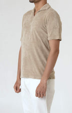 Short-sleeved terry polo shirt with open neck