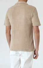Short-sleeved terry polo shirt with open neck
