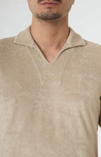 Short-sleeved terry polo shirt with open neck